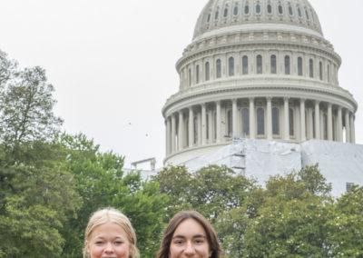两名学生在美国首都大楼前参加2023年青年巡回赛